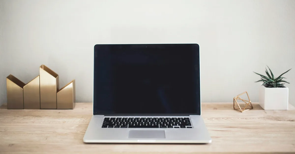 Options being compared on a laptop beside a notebook