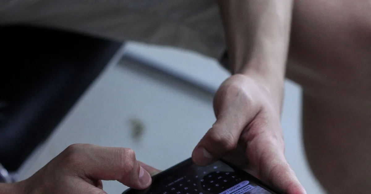 Someone using a messaging app on a phone