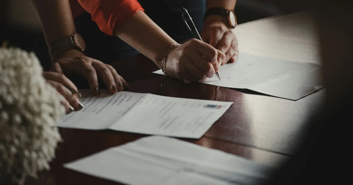 Legal documents being signed at a desk