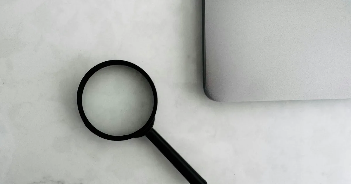 A magnifying glass over documents on a desk