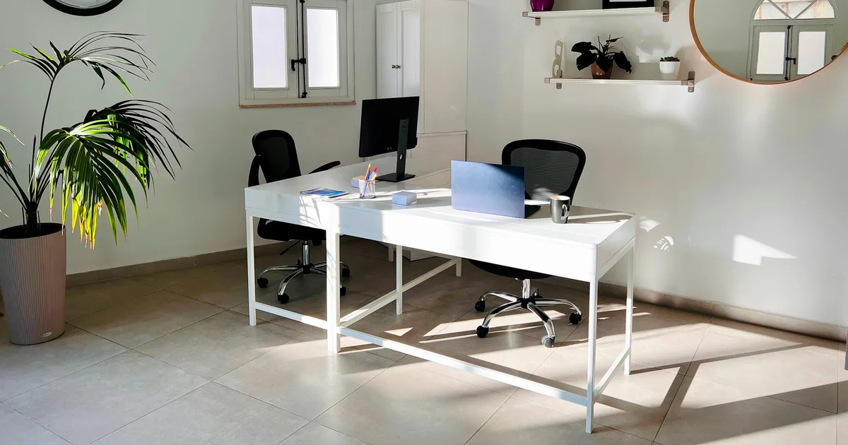 A bright modern workspace with a laptop by a window